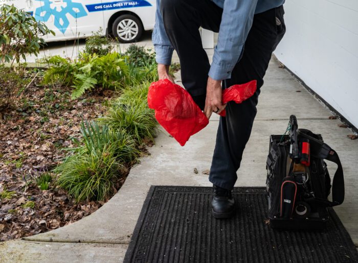 Pacific Heating and Cooling technicians wear protective shoe covers, commonly know as 