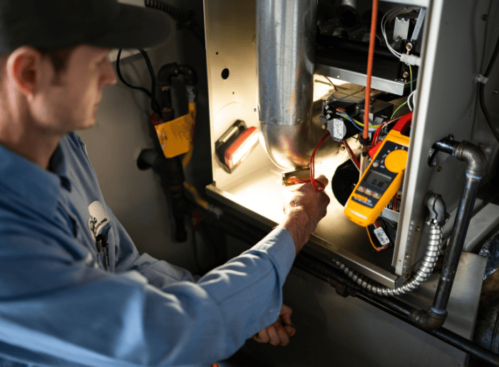 Technician performing heating maintenance in Tacoma home