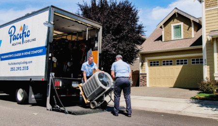 HVAC installation crew unloading new cooling equipment at a home