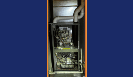 Furnace cabinet open during inducer motor diagnostic service call in Tacoma WA — Pacific Heating & Cooling technician