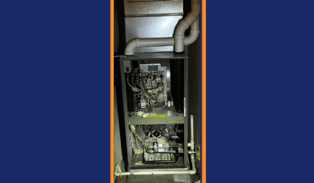 Furnace cabinet open during inducer motor diagnostic service call in Tacoma WA — Pacific Heating & Cooling technician