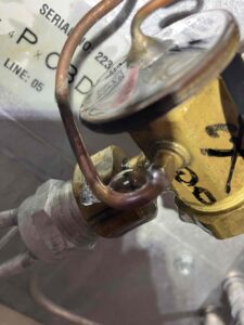 Soap bubble forming at a flare fitting during an AC refrigerant leak test in Tacoma