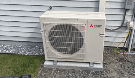 Mitsubishi ductless mini-split wall mount head installed in living room in Tacoma WA 98444