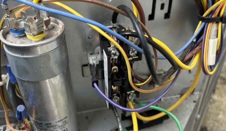 AC capacitor and contactor inside outdoor condenser unit during service call in Tacoma