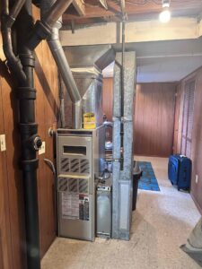 Aging gas furnace in a Tacoma basement before Pacific's full system installation