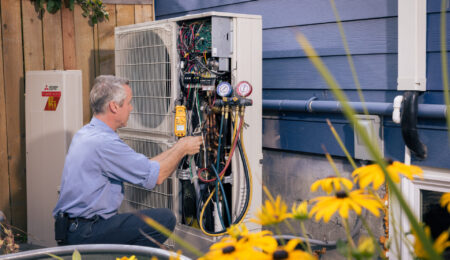 Technician performing regular HVAC maintenance to lower energy bills in Tacoma
