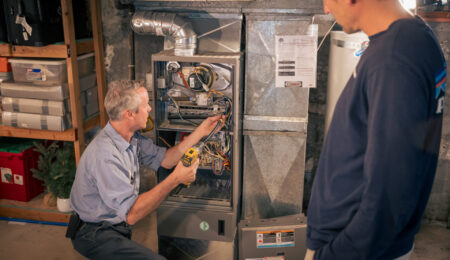 Pacific technician explaining HVAC maintenance findings to a Tacoma homeowner File name: hvac-maintenance-tacoma-technician-homeowner.jpg