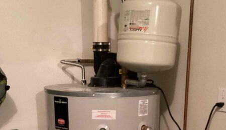 Water heater expansion tank mounted on the cold water line above a gas water heater