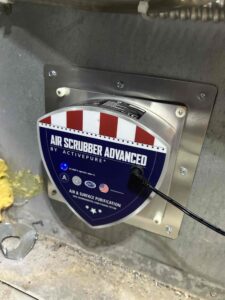 Air Scrubber Advanced by ActivePure unit installed in HVAC ductwork, UV lamp lit