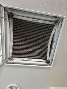 Clogged air filter in a ceiling return vent restricting airflow and causing uneven home temperatures
