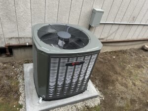 New Trane heat pump outdoor unit installed on a pad at a Puyallup home as part of a hybrid heating system