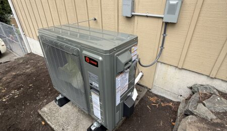 Tacoma heat pump installation with a new Trane outdoor unit beside the home